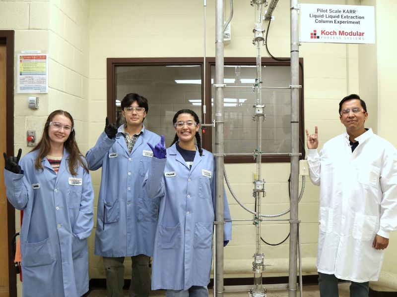 Students in front of the KARR® Liquid-Liquid Extraction column.