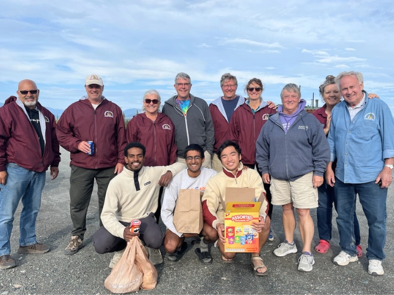 Wang pauses with RV travelers he and his team met in Canada.