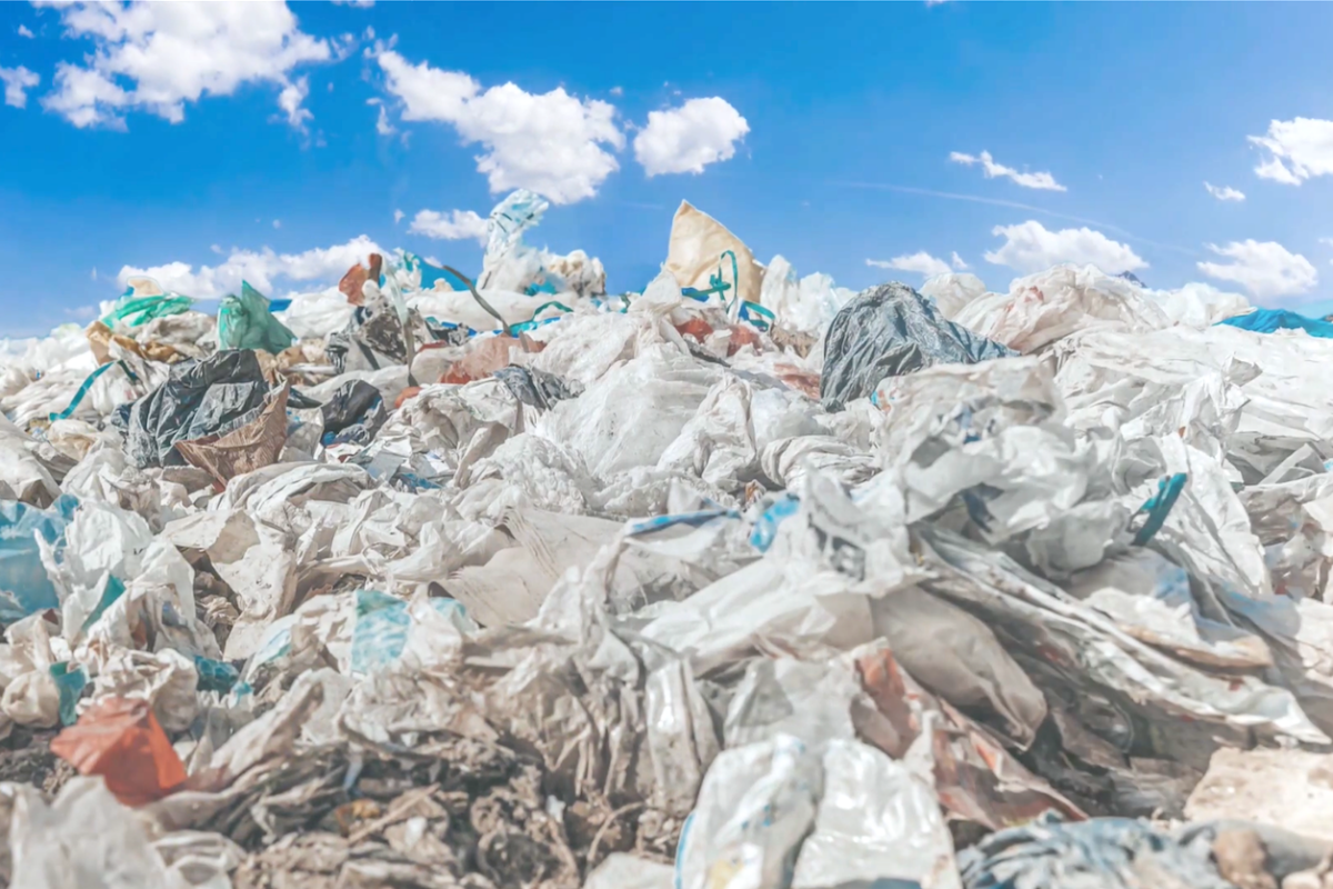 A pile of plastic bottles and other plastic waste at a landfill