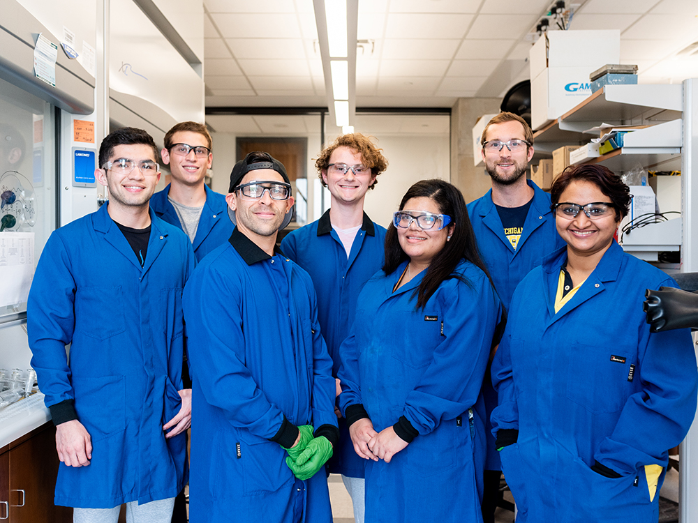 group of students in lab coats in lab