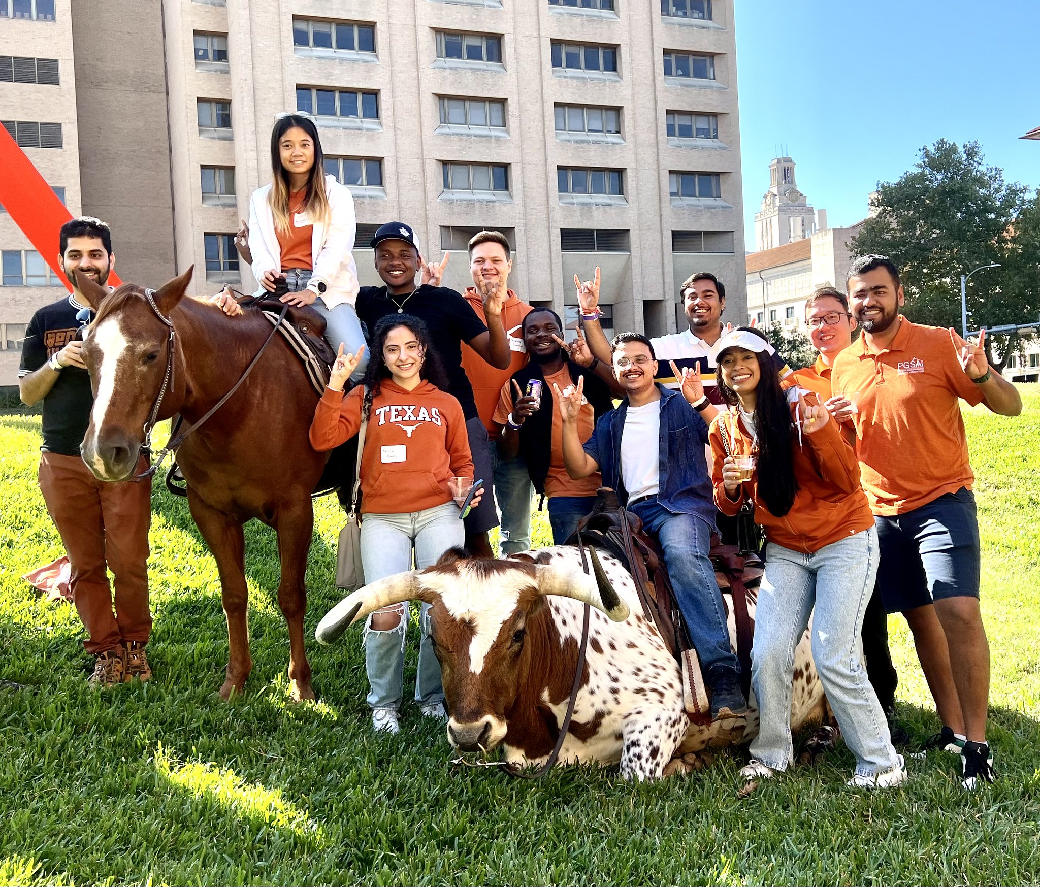 Texas chemical engineers smiling next to Ben the Longhorn