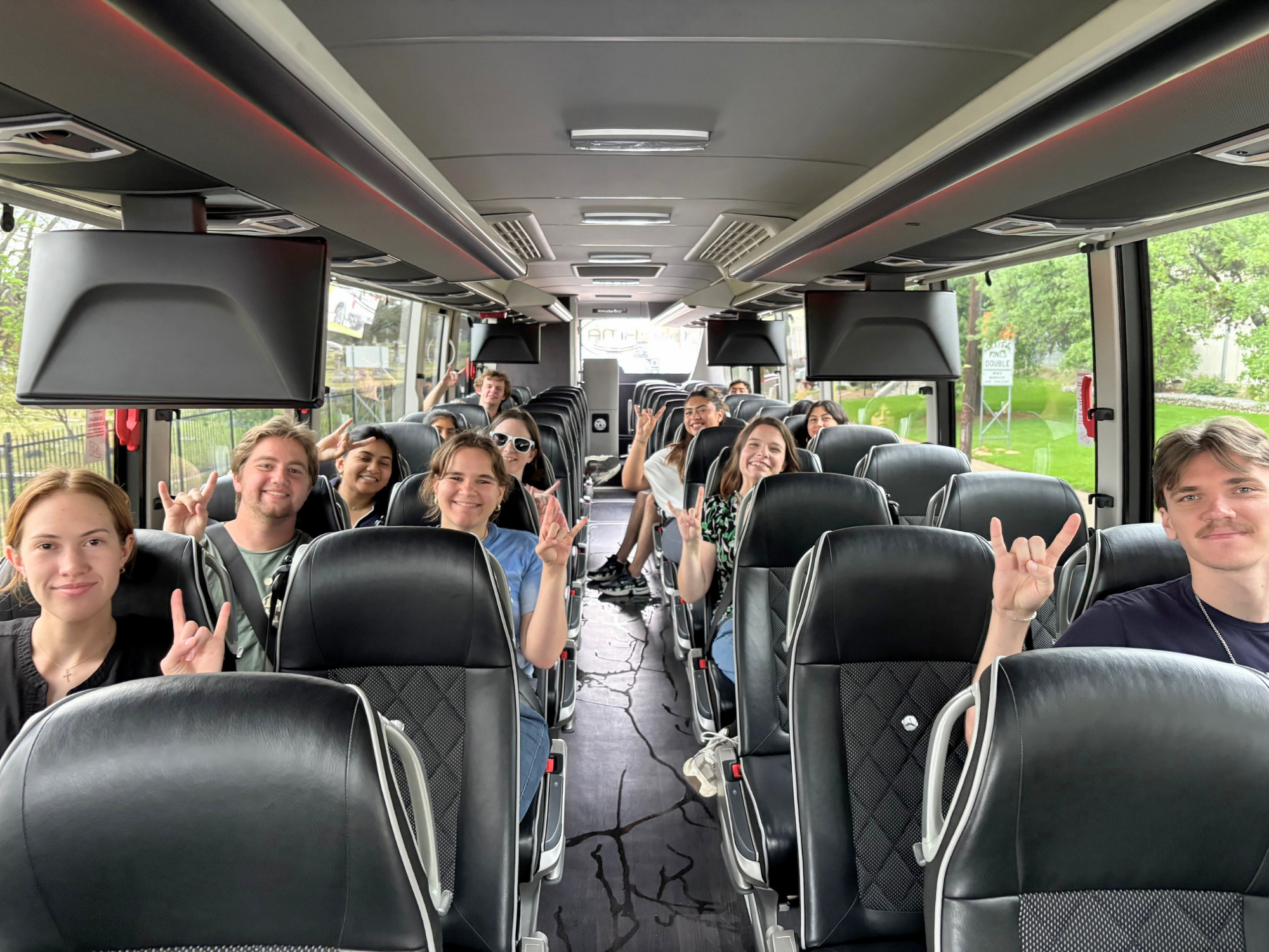 Fourth-year Texas ChE students waving from a bus