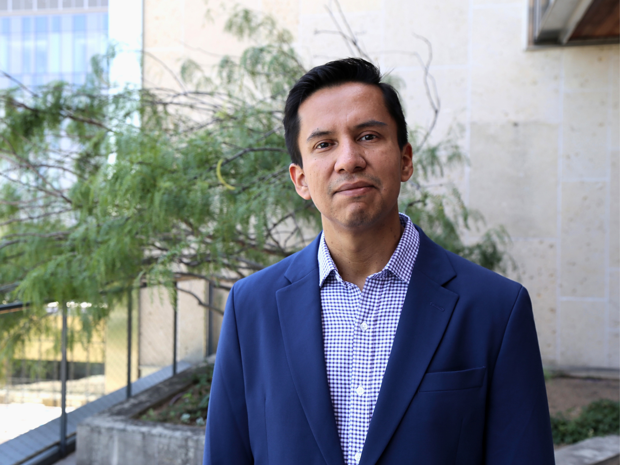 Carlos Landaverde-Alvarado give soft smile in EER building