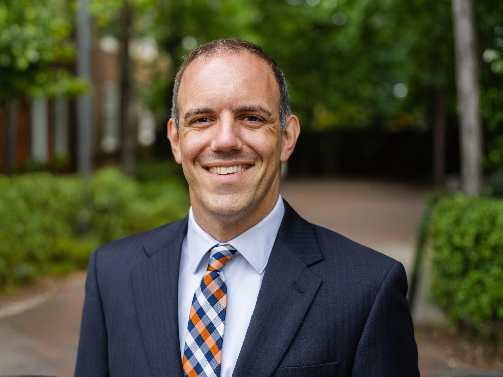 Professor Geoffrey M. Geise smiles at the camera
